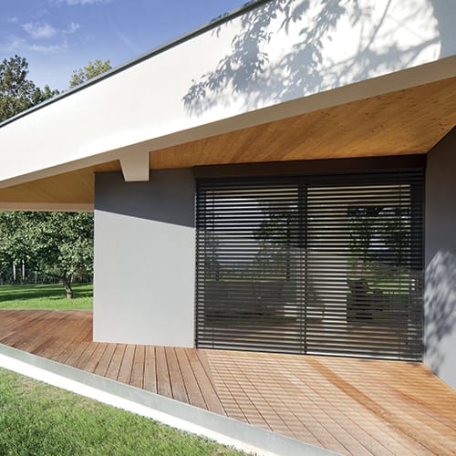 Maison moderne équipée d'un brise soleil orientable rénovation noir, terrasse en bois